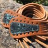 A close up of the leather and metal belt
