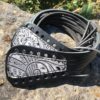A black belt with white designs on it