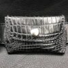 A black leather wallet with a silver heart on the front.