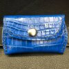 A blue wallet sitting on top of a table.