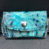 A blue wallet sitting on top of a table.