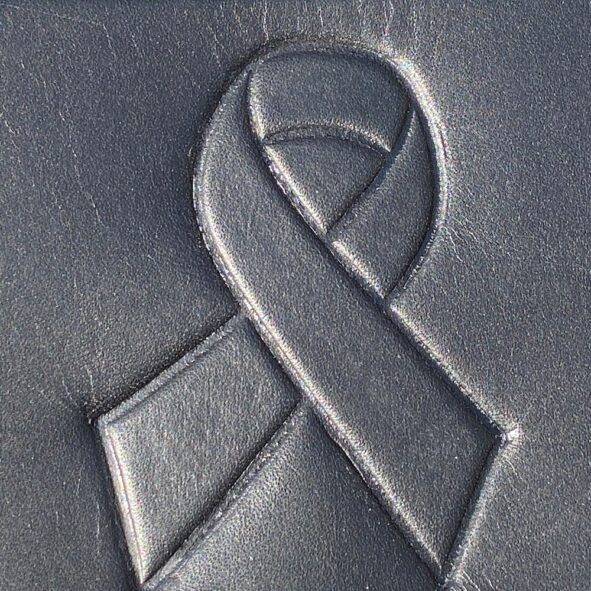 A close up of the ribbon on a leather wallet