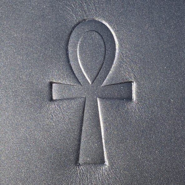 A cross symbol etched into the ground.