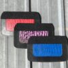 Three alligator-print leather pouches.