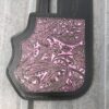 A pink and black wallet with some paisley designs
