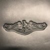A silver metal object with two dragons on it.