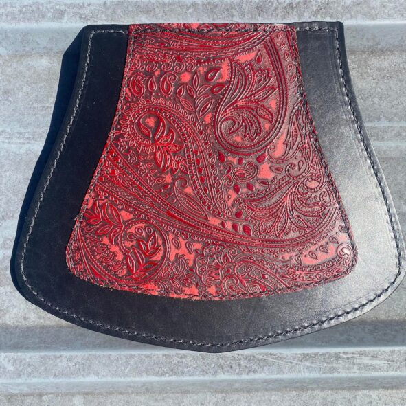 A red and black purse sitting on top of steps.