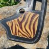 A guitar case with a zebra print on it.