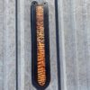 A metal wall with some type of object hanging on it