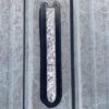 A metal door with a black handle and a silver background.