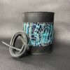 A leather wrapped candle holder with blue and black design.