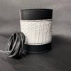A white and black leather bracelet with a string of black.