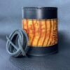 A leather wrapped can sitting on top of a table.