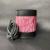 A black leather cuff with pink and white print.