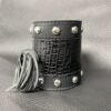 A black leather cuff with silver studs and rivets.