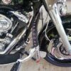 A motorcycle with the seat on and the brake pedal up.
