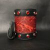 A red and black leather cuff with some red stones