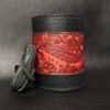 A black and red leather cup holder with a red paisley design.