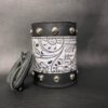 A leather cuff with a black and white design.