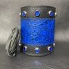 A blue and black leather cuff with silver studs.