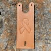 A leather phone case with a ribbon on it.
