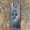 A leather key holder with an ankh symbol on it.