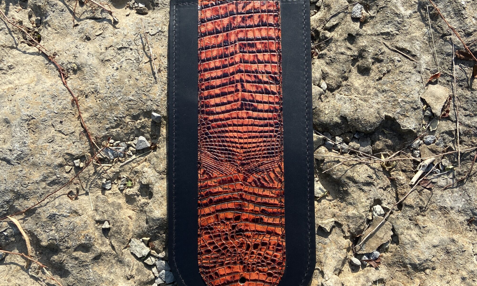 A close up of the top part of a leather bookmark