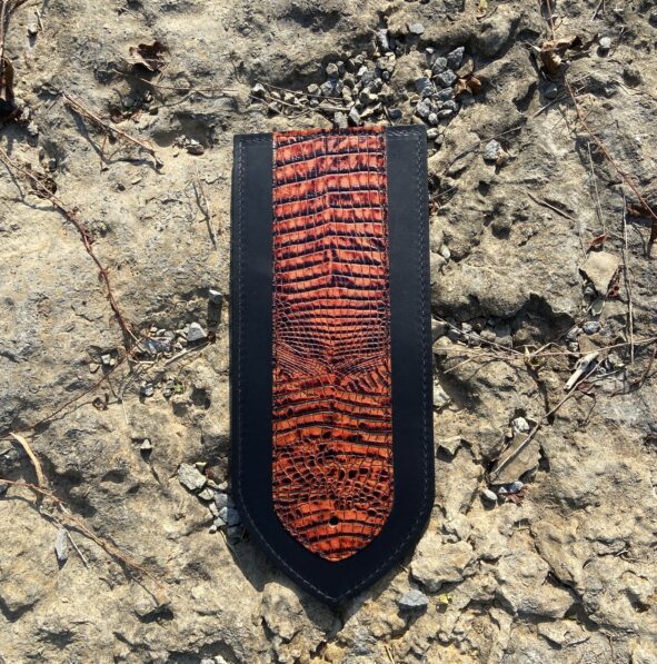 A close up of the top part of a leather bookmark