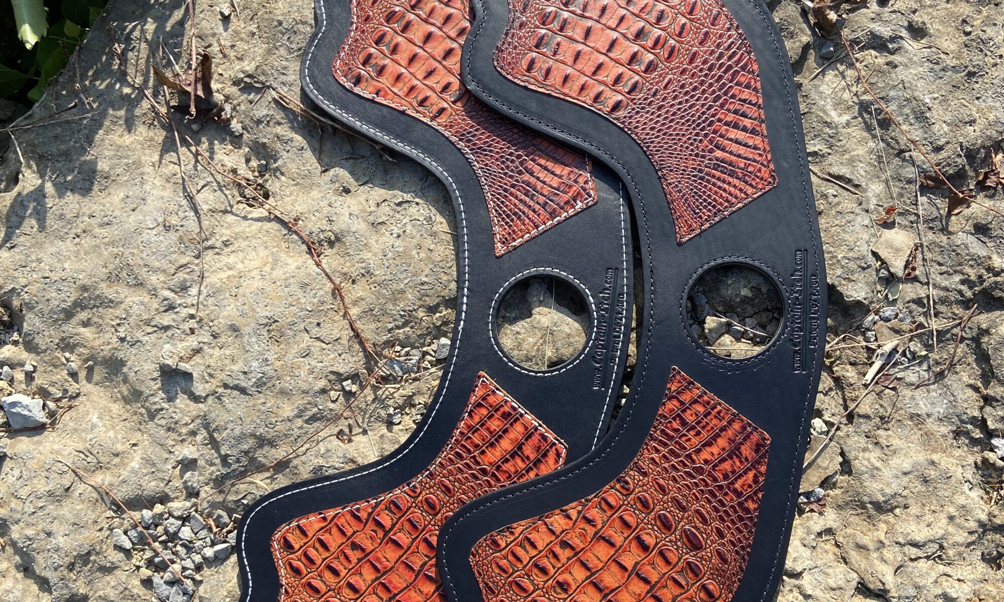 A close up of the bottom part of an orange and black shoe.