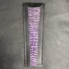 A purple and black leather wallet with a zebra print.
