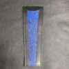 A blue and black knife sheath on a table.