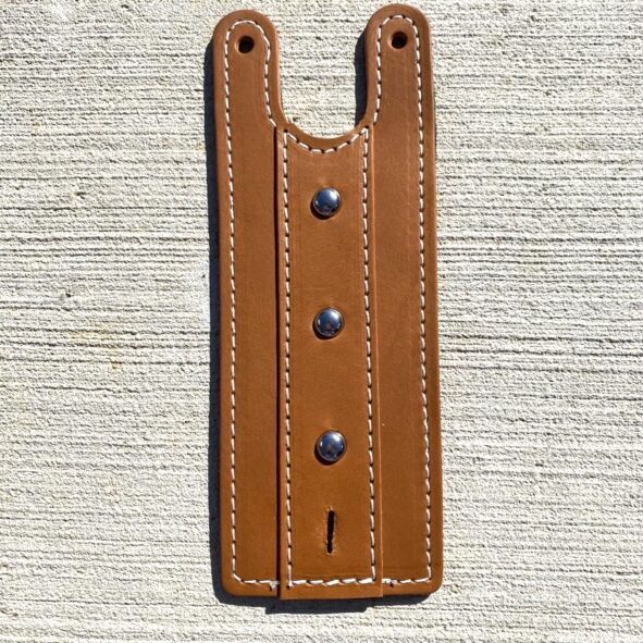 A brown leather wallet with rivets on the front.