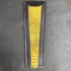 A yellow strip of paper on top of a table.
