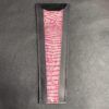 A pink and black striped leather wallet