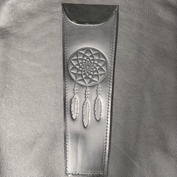 A leather case with a dreamcatcher design on it.