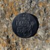 A black coin with the word " usn " on it.