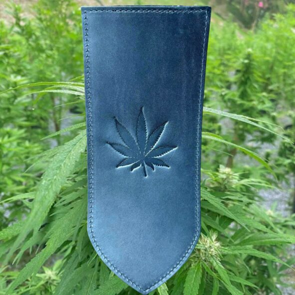 A blue leather bookmark with a marijuana leaf on it.