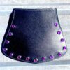 A black leather purse with purple rivets on it.