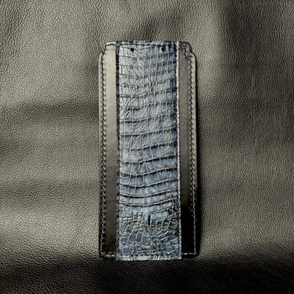 A cell phone case made of leather and metal.