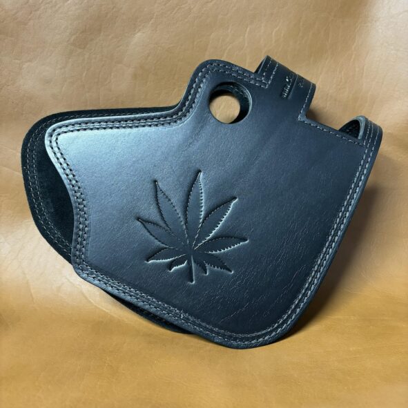 A black leather case with a leaf on it.