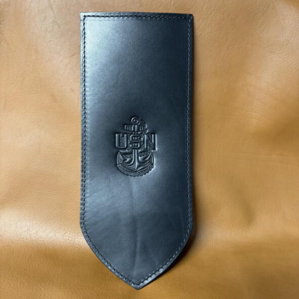 A black leather case with a crest on it.