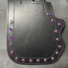 A black leather case with purple stones on it.