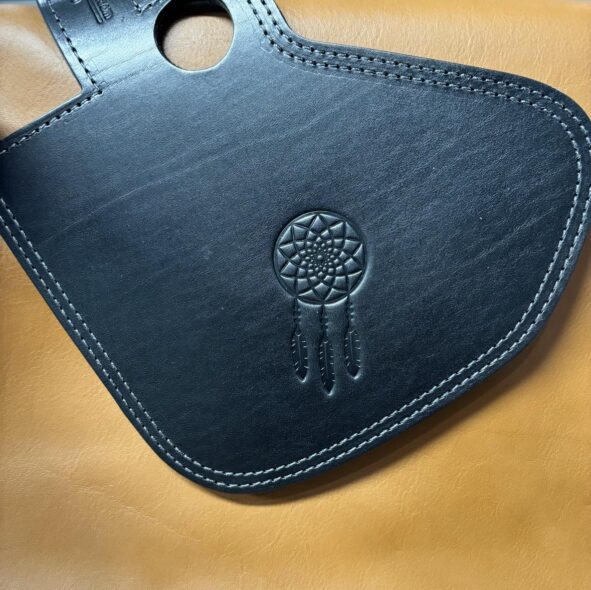 A black leather case with a dreamcatcher on it.