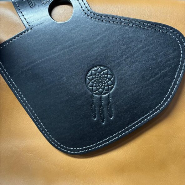 A black leather case with a dreamcatcher on it.