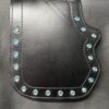 A black leather case with blue stones on it.